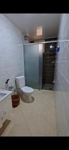 a bathroom with a toilet and a shower and a sink at اولاد بونار in Jijel