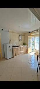 a large kitchen with a refrigerator and a stove at اولاد بونار in Jijel