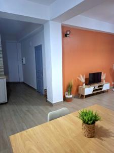 a living room with a table and a couch at Amana in Bandraboua