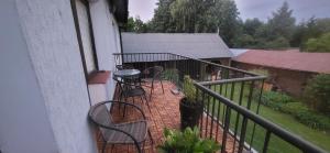 a balcony with two chairs and a table at Pokoje u Irenki in Augustów