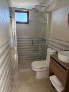 a bathroom with a toilet and a shower and a sink at Atalaya Green Nest in Estepona +2 photos