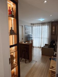 a living room with a couch and a desk in a room at nityloft com piscina e academia em Icaraí in Niterói