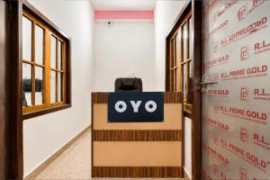 an open door with an ovy sign in a room at SPOT ON ROYAL KING HOTEL in Lucknow