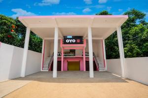 a pink and white building with a sign on it at SPOT ON ROYAL KING HOTEL in Lucknow +26 photos