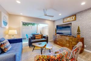 a living room with a couch and a tv at Castles Reach in Anaheim