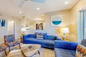 a living room with a blue couch and chairs at Castles Reach in Anaheim