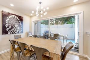 a dining room with a wooden table and chairs at Castles Reach in Anaheim