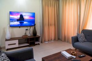 a living room with a flat screen tv on a wall at 903 . Spacious 3BR Apt. 2 Baths Gated Community in Sheikh Zayed