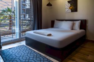 a bed in a room with a large window at 903 . Spacious 3BR Apt. 2 Baths Gated Community in Sheikh Zayed