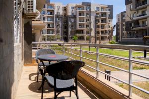 a balcony with a table and chairs and buildings at 903 . Spacious 3BR Apt. 2 Baths Gated Community in Sheikh Zayed
