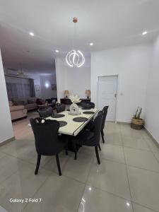 a dining table and chairs in a living room at 32 on Magasa in Blantyre