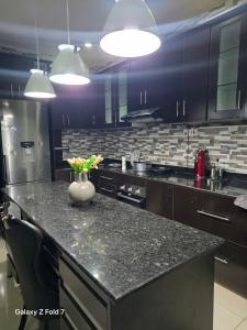 a kitchen with a counter with a vase of flowers on it at 32 on Magasa in Blantyre