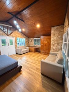 a large room with a bed and a couch at Villas by Helanka in Gonawala