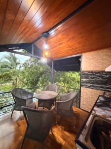 a patio with chairs and a table on a balcony at Villas by Helanka in Gonawala +4 photos