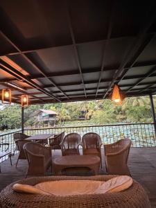 a group of chairs and tables on a patio at Villas by Helanka in Gonawala