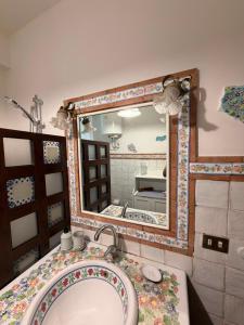 a bathroom with a sink and a mirror at Casa vacanze SALSEDINE in Mascali +87 photos