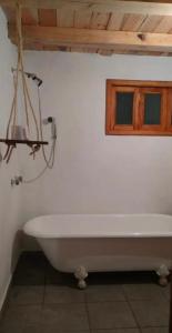 a white bath tub in a bathroom with a window at Cabañas las Alazanas in Mazamitla +48 photos