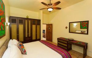 a bedroom with a bed and a ceiling fan at Casa Pura Paz in Puntarenas +20 photos