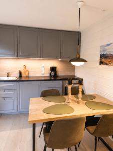 a kitchen with a wooden table and chairs at Tyinkrysset apartment in Tyinkrysset
