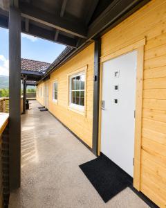a large white garage door on a wooden building at Tyinkrysset apartment in Tyinkrysset