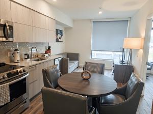 a kitchen with a table and chairs in a room at Premier Downtown Koreatown Apartment in Los Angeles