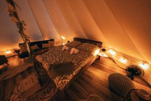 a person laying on a bed in a room at Zálesie Glamping in Kostolná Ves +16 photos