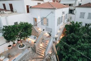 an overhead view of a white house with stairs and trees at Calais Boutique Apartments in Hydra