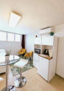 a small kitchen with a table and a refrigerator at Petit Biscuit - Wi-Fi - Kitchen - AC - Parking in Lido di Camaiore