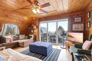 a living room with a couch and a ceiling fan at Chalet #29 in Stevensville