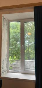 a window with a view of a tree at Rails and Vines in Tsinandali