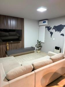 a living room with a couch and a tv at Olivia apart in Chajarí