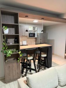 a kitchen with a table and chairs in a room at Olivia apart in Chajarí