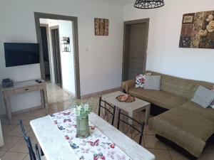 a living room with a couch and a table at Ioanna's Apartment in Potamiá