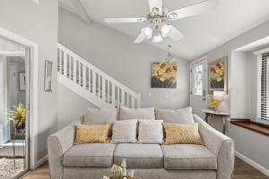 a living room with a couch and a ceiling fan at Stay at Cypress Cottage in Charleston +5 photos