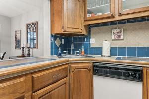 a kitchen with wooden cabinets and a sink at Stay at Cypress Cottage in Charleston