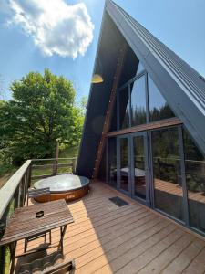 a large deck with a hot tub on top of a house at Лісовий Трикутник in Mykulychyn