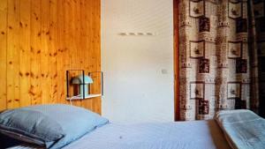 a bedroom with a bed and a lamp on a wall at Dorfgastein Mountain Property - Charming in Dorfgastein
