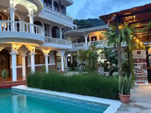a hotel with a swimming pool in front of a building at Gutierrez Hotel in Panajachel