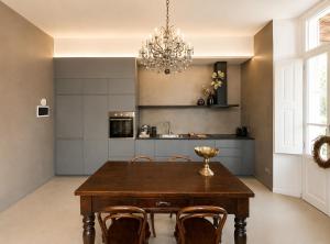 a kitchen with a table and chairs and a chandelier at Casa Vacanza Baragiola4 - Hotel San Giuseppe Group in Cernobbio