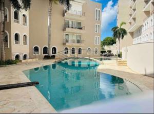 a swimming pool in front of a building at Ocean View Serenity in Cupecoy
