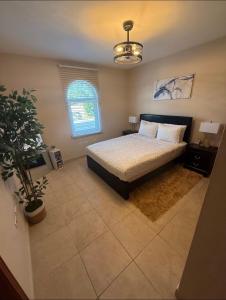 a bedroom with a bed and a potted plant at Ocean View Serenity in Cupecoy