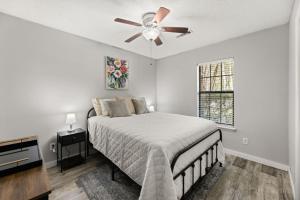 a bedroom with a bed and a ceiling fan at A Peaceful stay at The Pine Grove Retreat in Ladson +13 photos