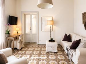 a living room with a white couch and a table at Casa Vacanza Baragiola4 - Hotel San Giuseppe Group in Cernobbio +4 photos