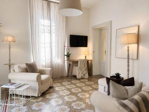 a living room with two couches and a table at Casa Vacanza Baragiola4 - Hotel San Giuseppe Group in Cernobbio