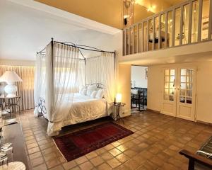 a bedroom with a bed with a canopy at Auberge de Cassagne & Spa in Le Pontet +78 photos