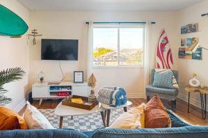 a living room with a blue couch and a window at Deep Blue Seaside in Monterey