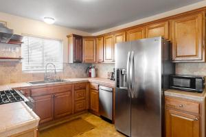 a kitchen with wooden cabinets and a stainless steel refrigerator at Deep Blue Seaside in Monterey +11 photos