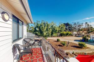a balcony with two chairs and a patio with a yard at See Star Ranch in Nipomo