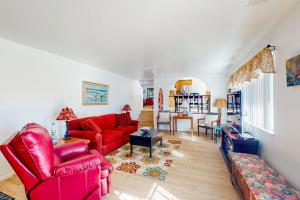 a living room with red chairs and a red couch at See Star Ranch in Nipomo