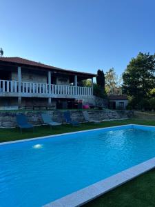 a swimming pool in the yard of a house at Casa dos Castros in Travassós